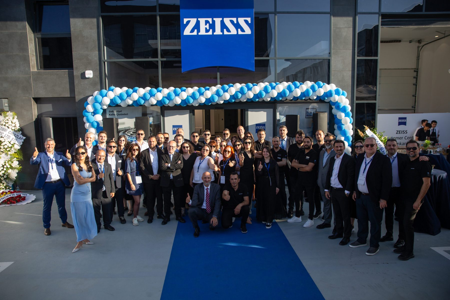 Opening day at the Zeiss Customer Center, Ankara — staff and guests under the Zeiss sign at the entrance