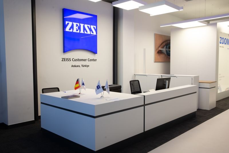 Photograph of the built reception desk and Zeiss sign